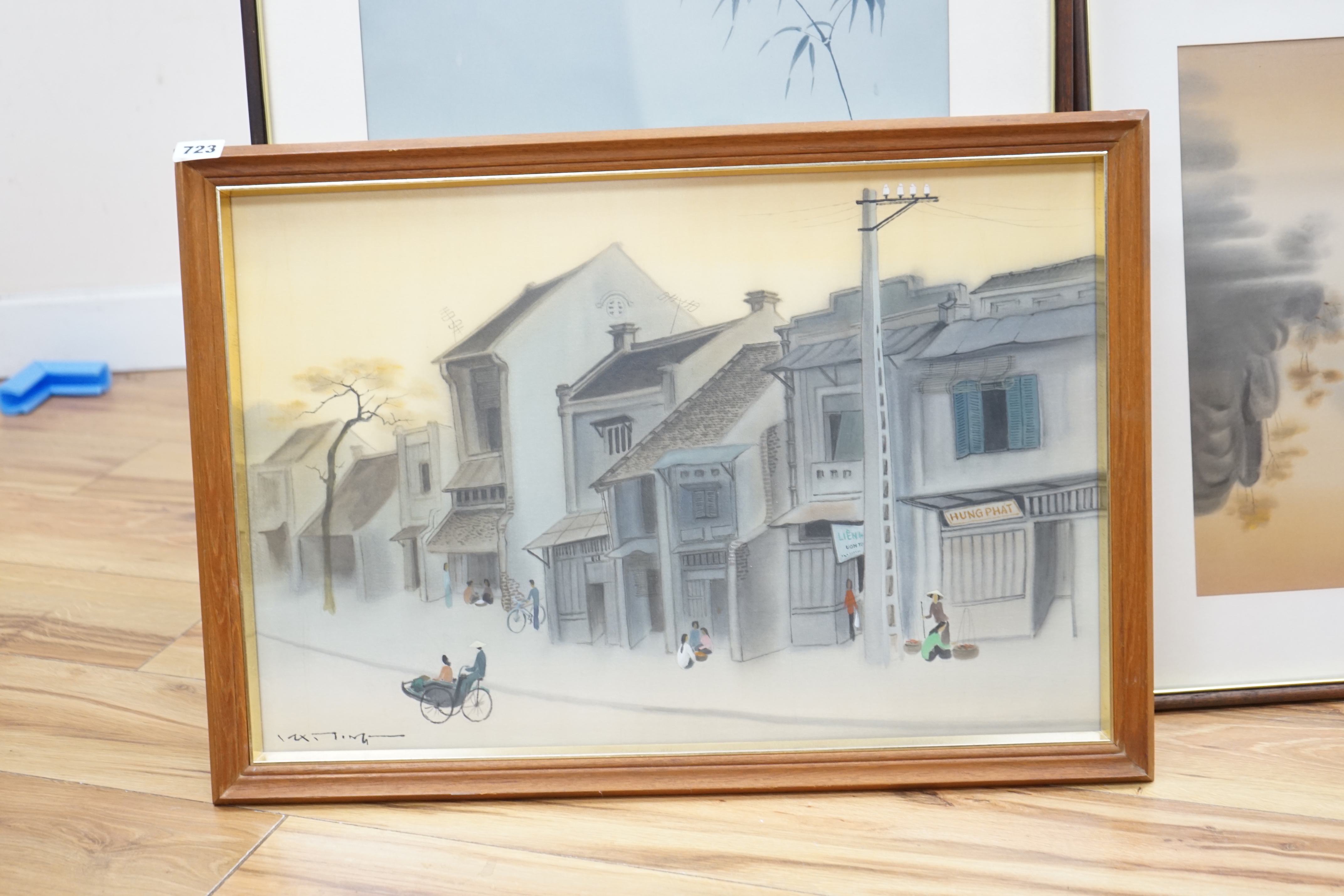 Four 20th century Vietnamese watercolour paintings on silk depicting street scene, lake scene and rice planting, all signed, largest 56 x 36cm, glazed frames